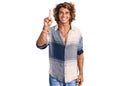 Young hispanic man wearing summer style showing and pointing up with finger number one while smiling confident and happy Royalty Free Stock Photo