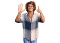 Young hispanic man wearing summer style showing and pointing up with fingers number six while smiling confident and happy Royalty Free Stock Photo