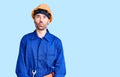 Young hispanic man wearing worker uniform making fish face with lips, crazy and comical gesture Royalty Free Stock Photo