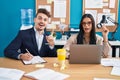 Young hispanic man and woman working at the office surprised with an idea or question pointing finger with happy face, number one Royalty Free Stock Photo