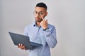 Young hispanic man working using computer laptop pointing to the eye watching you gesture, suspicious expression Royalty Free Stock Photo