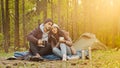 Young hispanic married couple tourists rest in woods camping man and woman in love drinking hot tea talking cute loving Royalty Free Stock Photo
