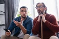 young hispanic man pointing with hand Royalty Free Stock Photo