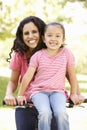 Young Hispanic Mother And Daughter Cycling In Park Royalty Free Stock Photo