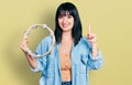 Young hispanic plus size woman playing tambourine smiling with an idea or question pointing finger with happy face, number one Royalty Free Stock Photo