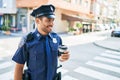 Young hispanic policeman wearing police uniform smiling happy