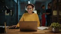 Young Hispanic Project Manager in Headphones and Working on Laptop Computer in Busy Creative Offic Royalty Free Stock Photo