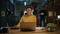 Young Hispanic Project Manager in Headphones and Working on Laptop Computer in Busy Creative Offic Royalty Free Stock Photo