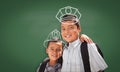 Young Hispanic Student Boy Wearing Backpack Front Of Blackboard with Fireman Helmet And Policeman Hat Drawn In Chalk Over Heads Royalty Free Stock Photo