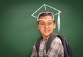 Young Hispanic Student Boy Wearing Backpack Front Of Blackboard with Graduation Cap Drawn In Chalk Over Head