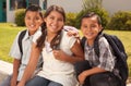 Young Hispanic Student Children Wearing Backpacks On School Campus