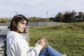 Young hispanic student writing in notebook while sitting in public park Royalty Free Stock Photo