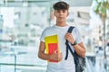 Young hispanic teenager student smiling confident holding books at university Royalty Free Stock Photo