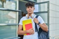 Young hispanic teenager student smiling confident holding books at university Royalty Free Stock Photo