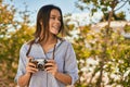 Young hispanic tourist girl smiling happy using camera at the park Royalty Free Stock Photo