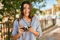 Young hispanic tourist girl smiling happy using camera at the park Royalty Free Stock Photo