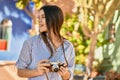 Young hispanic tourist girl smiling happy using camera at the park Royalty Free Stock Photo