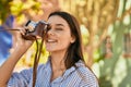 Young hispanic tourist girl smiling happy using camera at the park Royalty Free Stock Photo