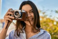 Young hispanic tourist girl smiling happy using camera at the park Royalty Free Stock Photo