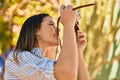 Young hispanic tourist girl smiling happy using camera at the park Royalty Free Stock Photo