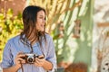 Young hispanic tourist girl smiling happy using camera at the park Royalty Free Stock Photo