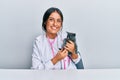 Young hispanic veterinary girl examining cat using stethoscope at the clinic