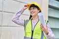 Young hispanic woman architect holding blueprints at street Royalty Free Stock Photo