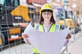 Young hispanic woman architect reading plans at street Royalty Free Stock Photo