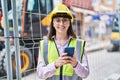 Young hispanic woman architect using smartphone at street Royalty Free Stock Photo