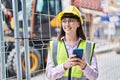 Young hispanic woman architect using smartphone at street Royalty Free Stock Photo