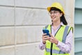 Young hispanic woman architect using smartphone at street Royalty Free Stock Photo