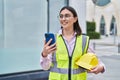 Young hispanic woman architect using smartphone at street Royalty Free Stock Photo