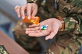 Young hispanic woman army soldier taking pills at home