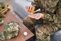 Young hispanic woman army soldier taking pills at home