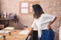 Young hispanic woman business worker suffering for backache at office Royalty Free Stock Photo