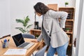 Young hispanic woman business worker suffering for backache at office Royalty Free Stock Photo