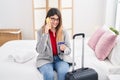 Young hispanic woman business worker talking on the smartphone holding credit card at hotel room Royalty Free Stock Photo