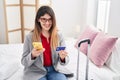 Young hispanic woman business worker using smartphone and credit card at hotel room Royalty Free Stock Photo