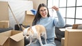 Young hispanic woman with chihuahua dog smiling holding new house keys at new home Royalty Free Stock Photo