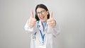 Young hispanic woman doctor doing thumbs up over isolated white background Royalty Free Stock Photo