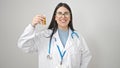 Young hispanic woman doctor holding pills over isolated white background Royalty Free Stock Photo