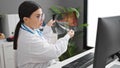 Young hispanic woman doctor on online appointment showing xray at clinic Royalty Free Stock Photo