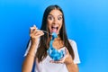 Young hispanic woman eating measure meter doing diet for weight loss celebrating crazy and amazed for success with open eyes Royalty Free Stock Photo