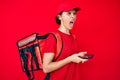 Young hispanic woman holding delivery box calling assistance angry and mad screaming frustrated and furious, shouting with anger Royalty Free Stock Photo