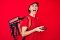 Young hispanic woman holding delivery box calling assistance angry and mad screaming frustrated and furious, shouting with anger Royalty Free Stock Photo