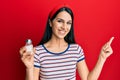 Young hispanic woman holding salt shaker smiling happy pointing with hand and finger to the side Royalty Free Stock Photo