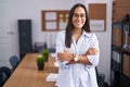 Young hispanic woman at the office happy face smiling with crossed arms looking at the camera Royalty Free Stock Photo