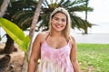 Young hispanic woman outdoors by the park looking positive and happy standing and smiling with a confident smile showing teeth Royalty Free Stock Photo