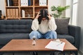 Young hispanic woman patient depressed having psychology session at clinic Royalty Free Stock Photo