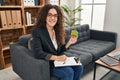 Young hispanic woman playing colorful puzzle cube intelligence game looking positive and happy standing and smiling with a